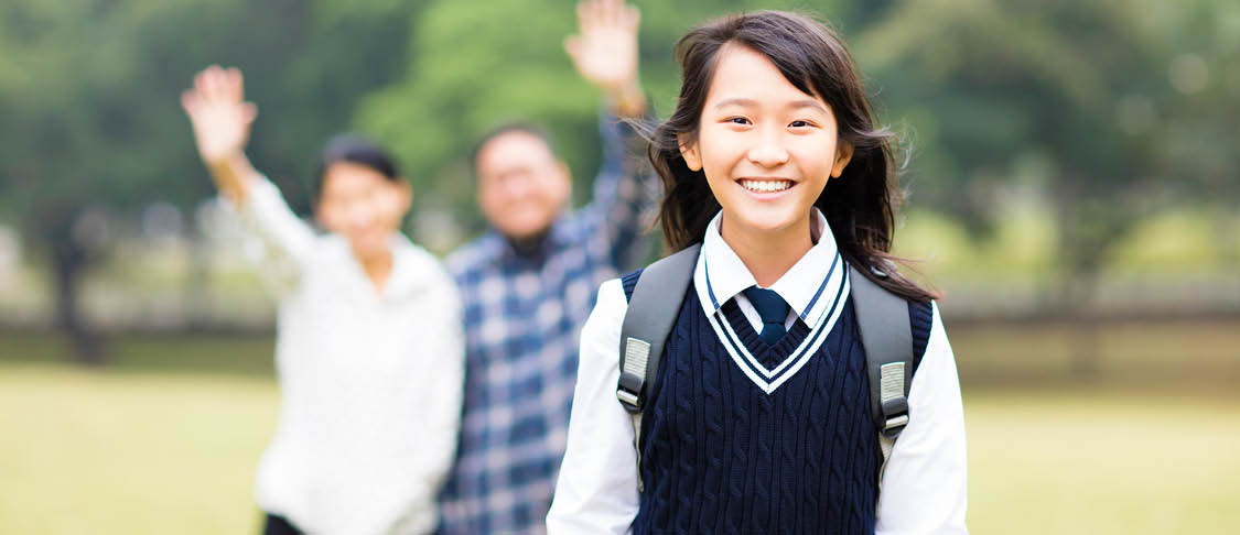 Parents waving young international student off to school